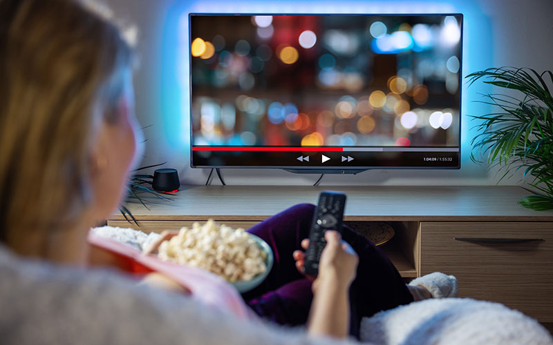 woman watching Netflix with popcorn
